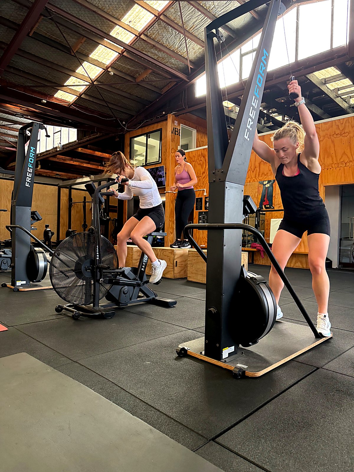 Member powering through a cardio interval on the assault bike